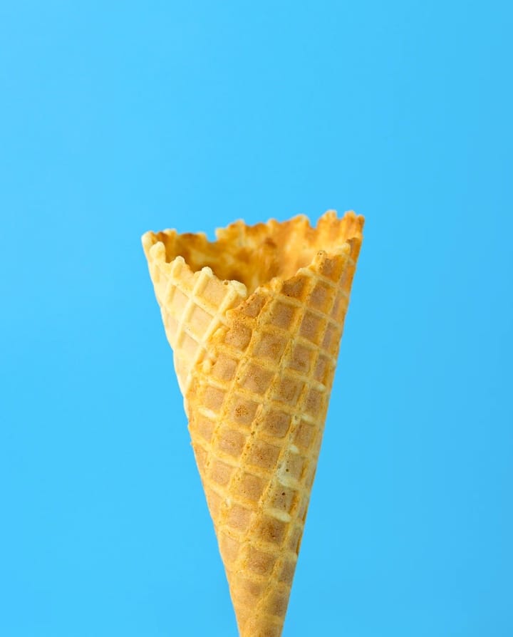 Waffle cone next to blue background